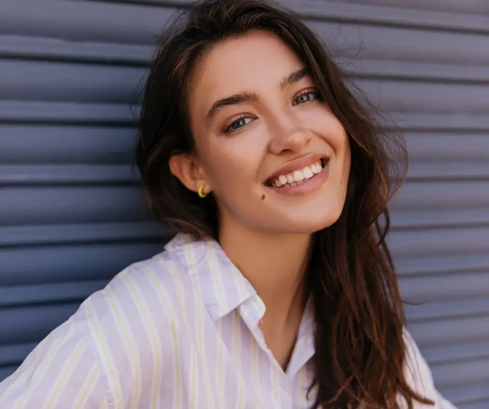 raleigh fillers model smiling with beauty mark